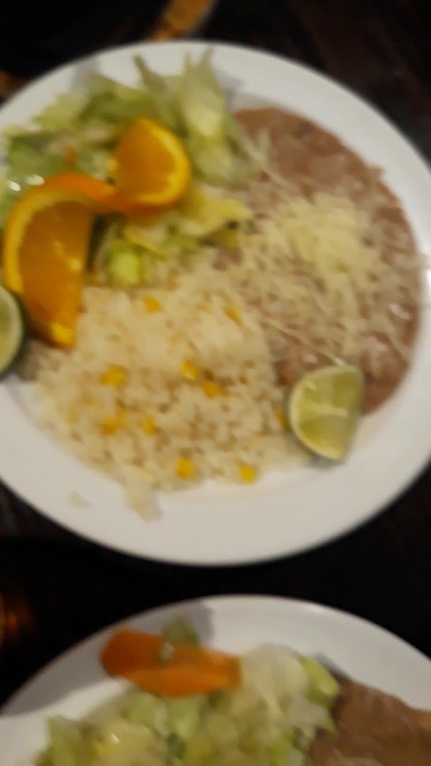 Seafood plates served with rice and garnishes.